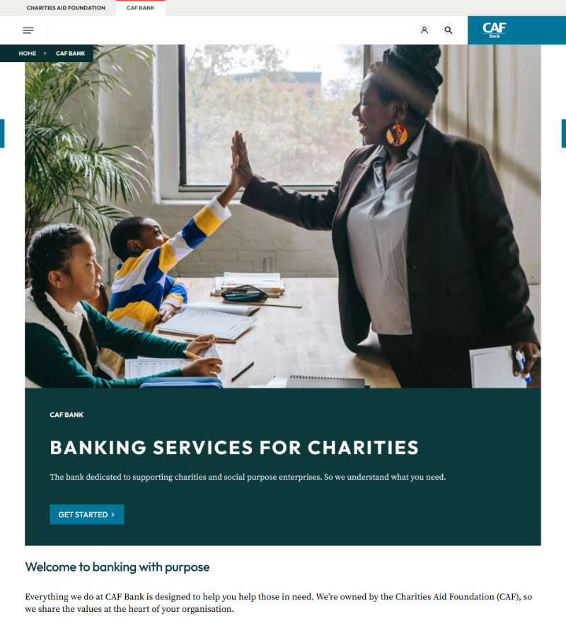 A screenshot of the CAF bank home page, with a huge photograph of two people giving a high five